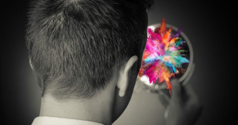 A man looking at his reflection in a mirror where a colorful explosion is bursting out of it